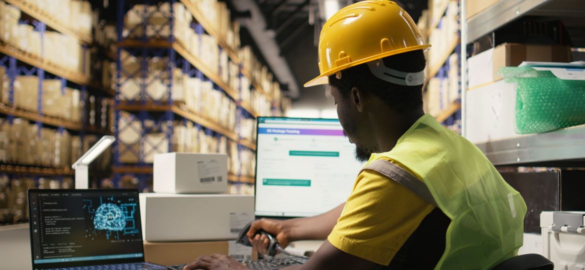Black employee works with AI tools to enhance package tracking efficiency